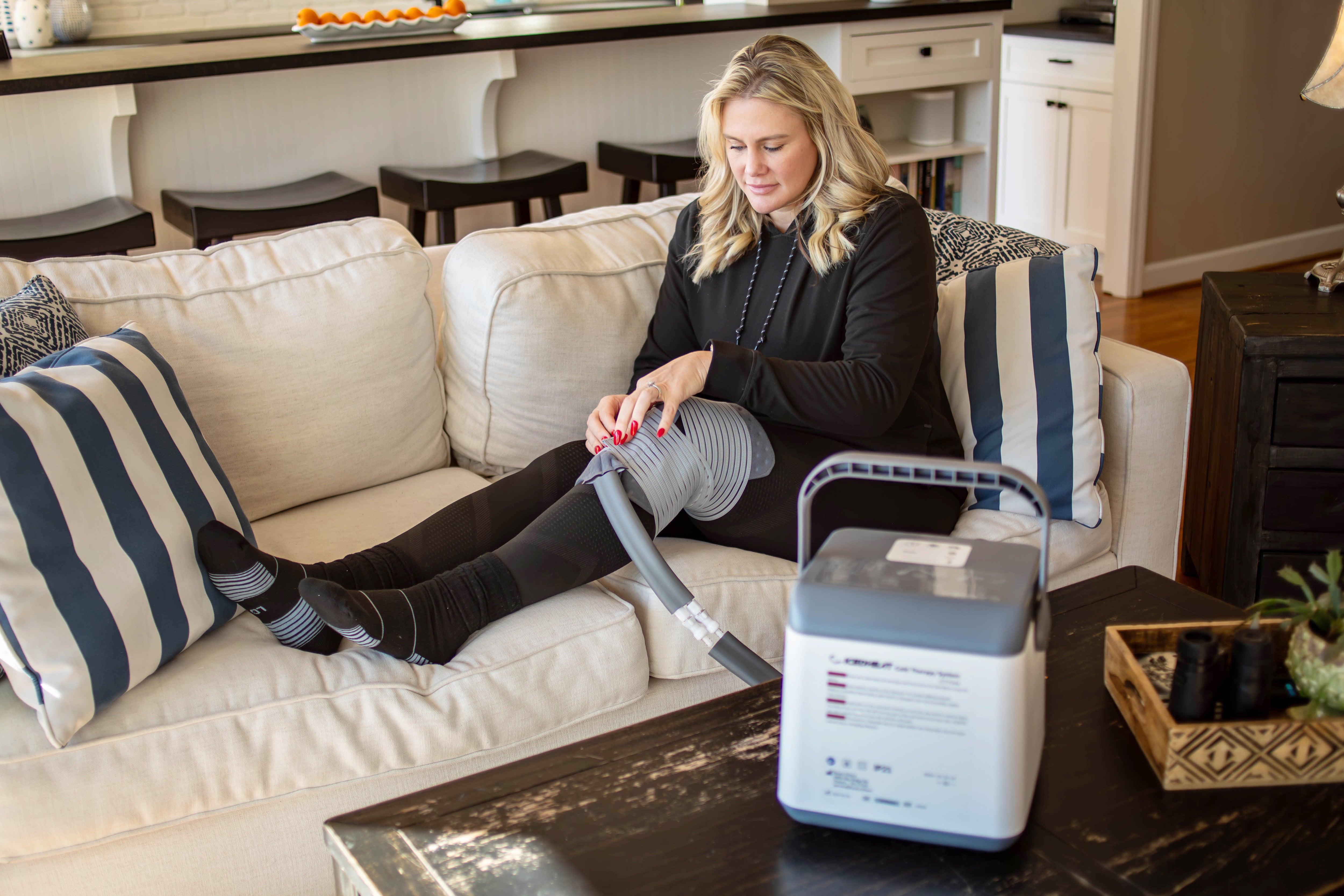 Brittany Jackson, former Lady Vol basketball player, using the Brace Direct IcedHeat Hot and Cold Therapy Machine on her knee for athlete recovery