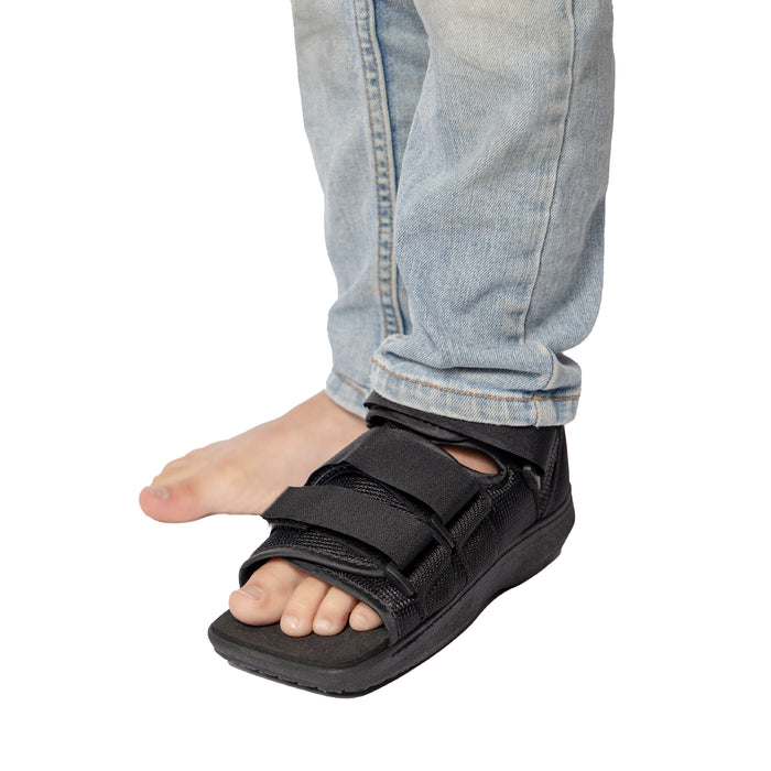 Front view of the Brace Align Pediatric Children's Post-Op Shoe, worn by a model.