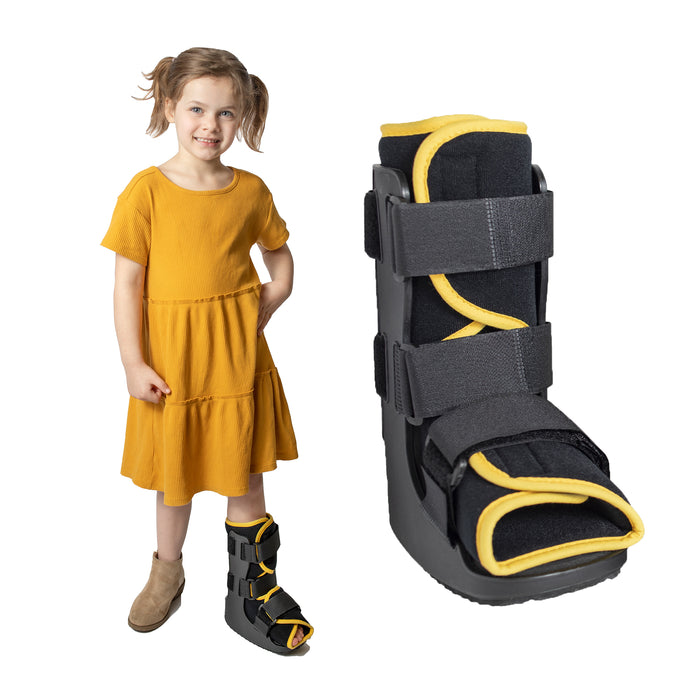 A smiling girl demonstrates the fit of the green Brace Direct Pediatric Walker Fracture Boot, beside a front view of the boot in yellow.