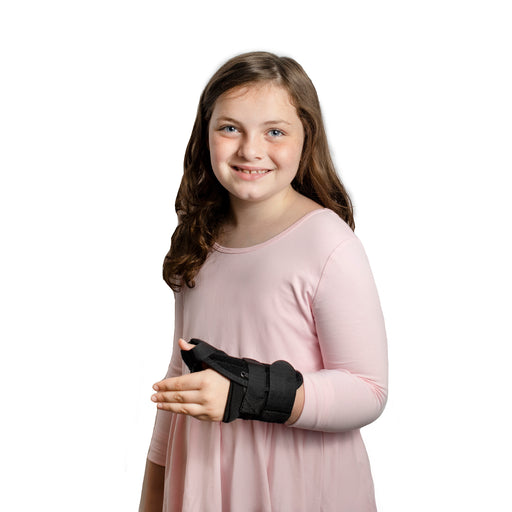 A smiling girl demonstrates the fit of the Brace Direct Pediatric Wrist Splint & Thumb Spica.
