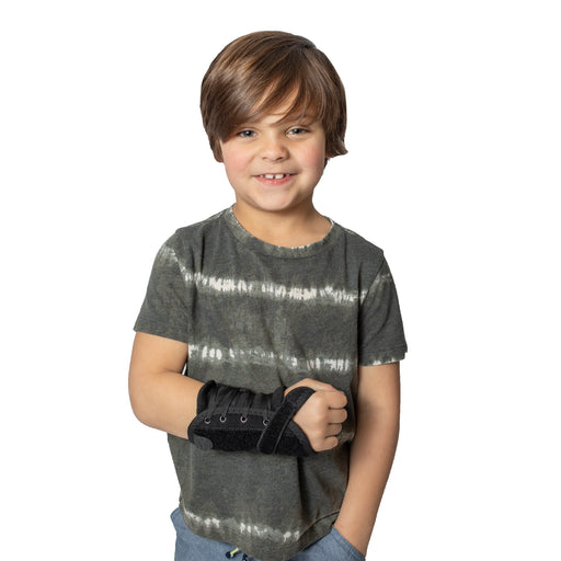 A smiling boy demonstrates the fit of the Brace Align Pediatric Wrist Brace L3908.