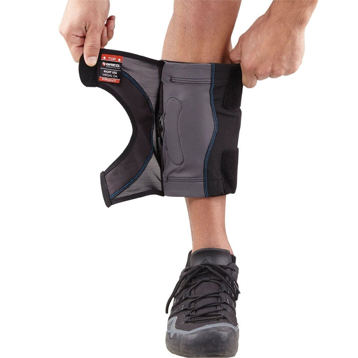 Man demonstrates how to fit the Breg FreeSport Athletic Knee Support Brace, step 2: close the Velcro closures.