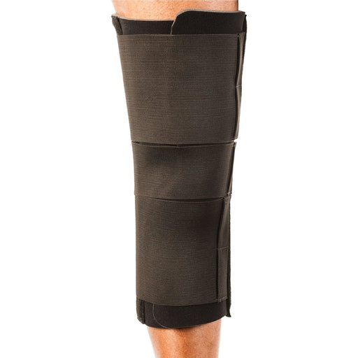 Rear view of the Breg Single Panel Compression Knee Immobilizer by Brace Direct, worn by a model.