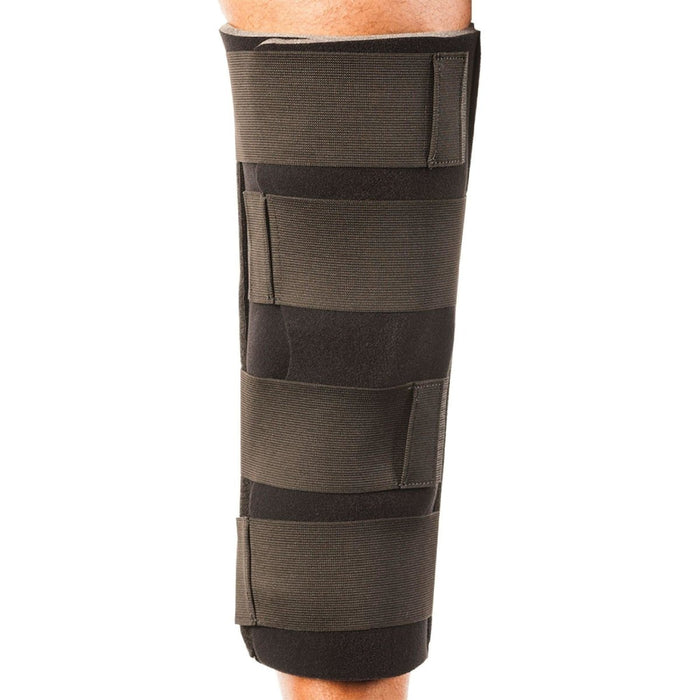 Rear view of the Breg Single Panel Knee Immobilizer by Brace Direct, worn by a model.