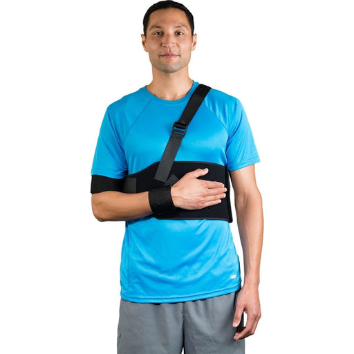 A smiling model demonstrates the fit of the Breg Straight Shoulder Immobilizer Deluxe, by Brace Direct.