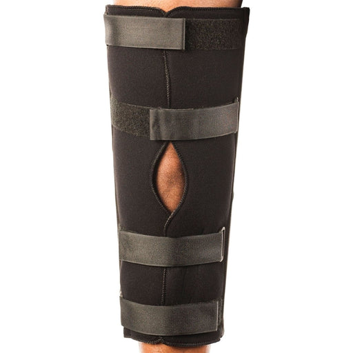 Front view of the Breg Tri-Panel Knee Immobilizer by Brace Direct, worn by a model.