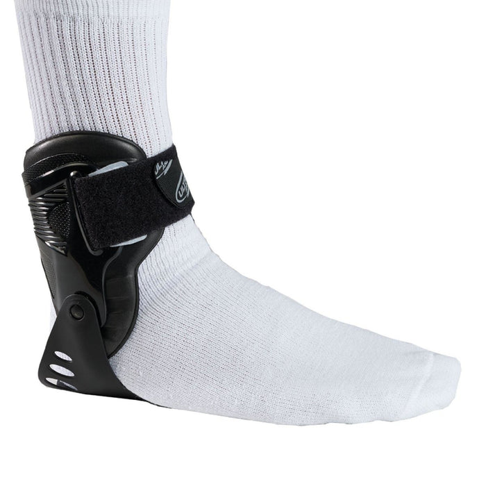 Side view of the Breg Ultra Aurora Stabilizing Ankle Brace by Brace Direct, worn by a model.