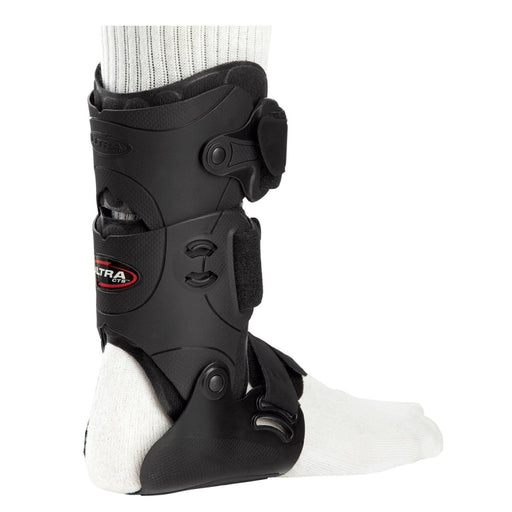 Right side view of the Breg Ultra CTS Ankle Recovery Support Brace with the detachable PerformaFit upright, worn by a model.
