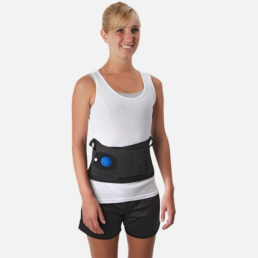 A smiling model demonstrates the fit of the Ossur Airform Inflatable Lumbar Back Support, by Brace Direct.